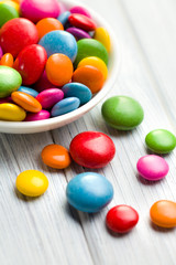 colored candy in white bowl