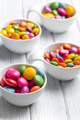 colored candy in white bowl