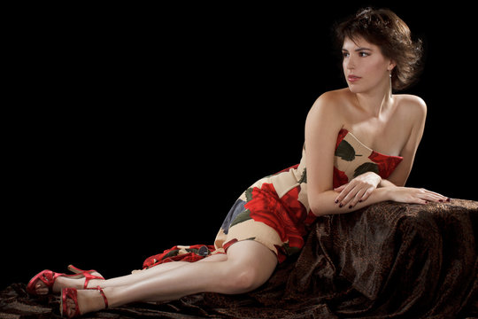 Beautiful sexy young woman in strapless long dress gracefully re
