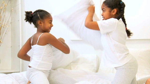 Cute African American Sisters Pillow Fight