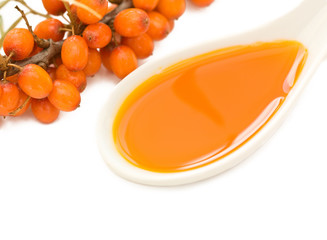 spoon with sea buckthorn oil  on a white background