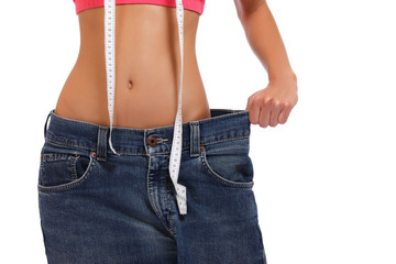 weightloss - woman showing loss of weight on white