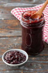 Homemade plum jam on wooden table