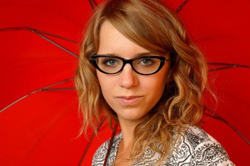 Girl in glasses with red umbrella © GieZetStudio