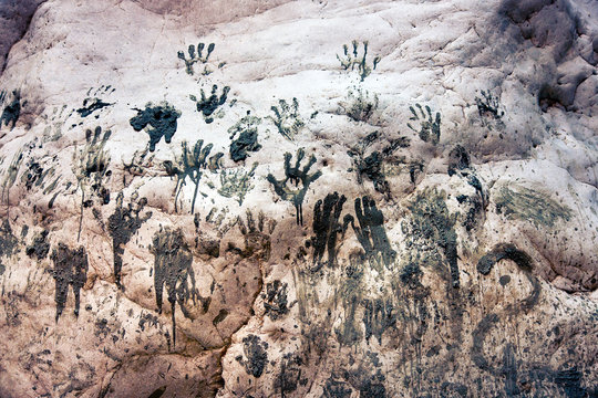 Handprints on a stone wall