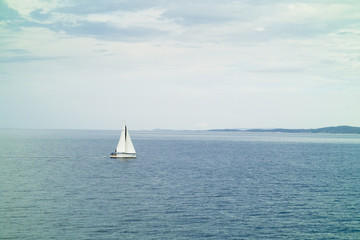 Fototapeta premium A small sailing yacht in the sea