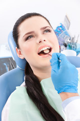 Dentist is looking for the defects in the oral cavity
