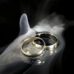 golden wedding rings and smoke