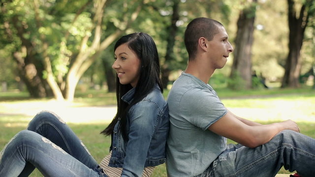 Portrait of young happy teenage couple in the park