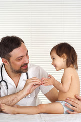 A beautiful nice doctor treats a child