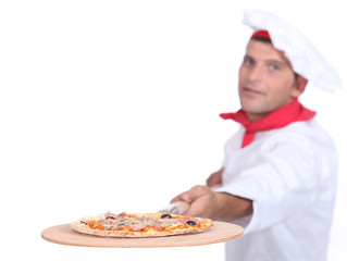 Cook serving pizza