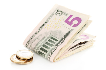 Dollar bills and coins isolated on white