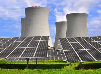Solar energy panels before a nuclear power plant
