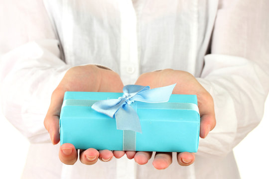 woman holds a box with a gift on white background close-up