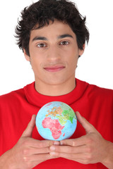 Man holding miniature globe