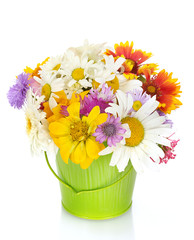beautiful bouquet of bright  wildflowers in green metal bucket,