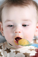 Baby boy eating vegetable mash
