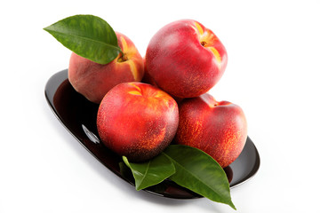 Fresh peaches and nectarines on a plate isolated on a white back