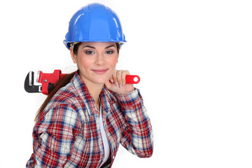 Tradeswoman holding a pipe wrench