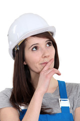 Portrait of a tradeswoman deliberating