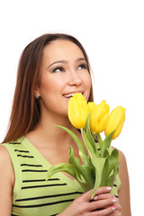 A smiling girl with yellow tulips, isolated on white
