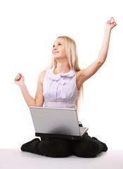 A young woman sitting on the floor with a laptop