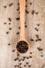 black pepper in wooden spoon