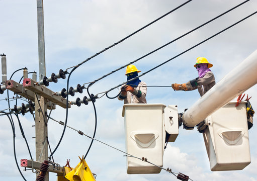 Electrical Worker In A Bucket Fixes A Problem With A Power Line