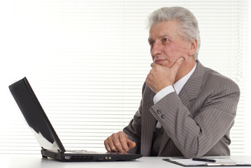 mature man sitting at the laptop