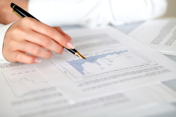 Hand of a woman pointing a graph