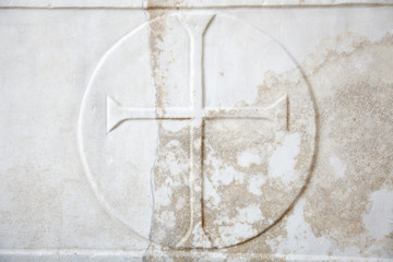 Cross carved in white marble background