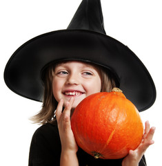 little witch holding a pumpkin on halloween time