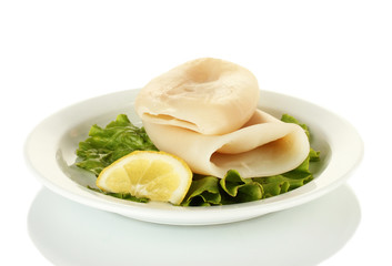 boiled squids with lettuce and lemon in the plate isolated