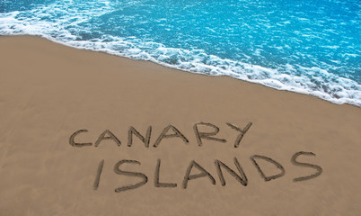 Brown beach sand written word Canary islands