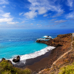 Fototapeta premium Beach el Bollullo black brown sand and aqua water