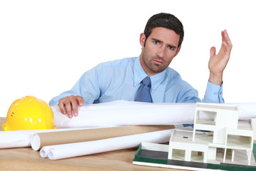 architect in his office looking angry