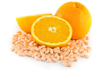 Orange fruit with vitamin c tablet  on white background
