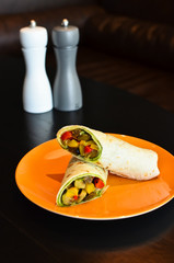 Fresh tortilla wraps with vegetables on the plate