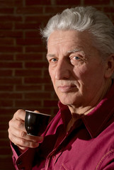 Caucasian elderly man with a nice cup