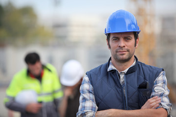 Confident foreman on construction site - obrazy, fototapety, plakaty