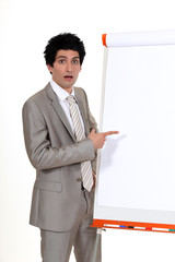 businessman pointing at a white board