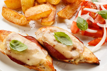Grilled chicken breasts with cheese and baked potatoes