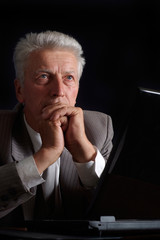 Pensive old man in suit