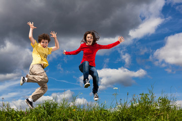 Fototapeta na wymiar Girl and boy running, jumping outdoor
