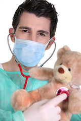 Doctor examining a teddy bear