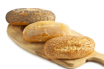 Fototapeta na wymiar three breads on the wooden plank