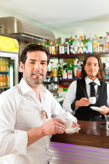 Barista with client in his cafe or coffeeshop
