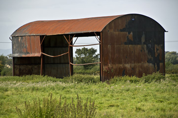 rusty barn in field © theclarkester