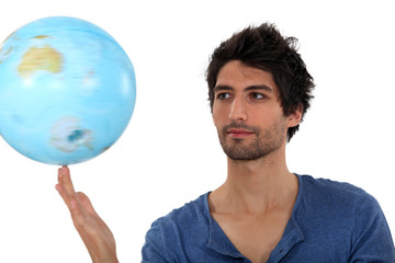 Man spinning a globe