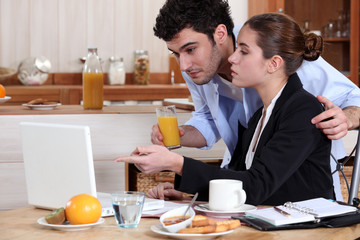 Business couple having breakfast at home